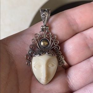 A sterling silver pendant- goddess face